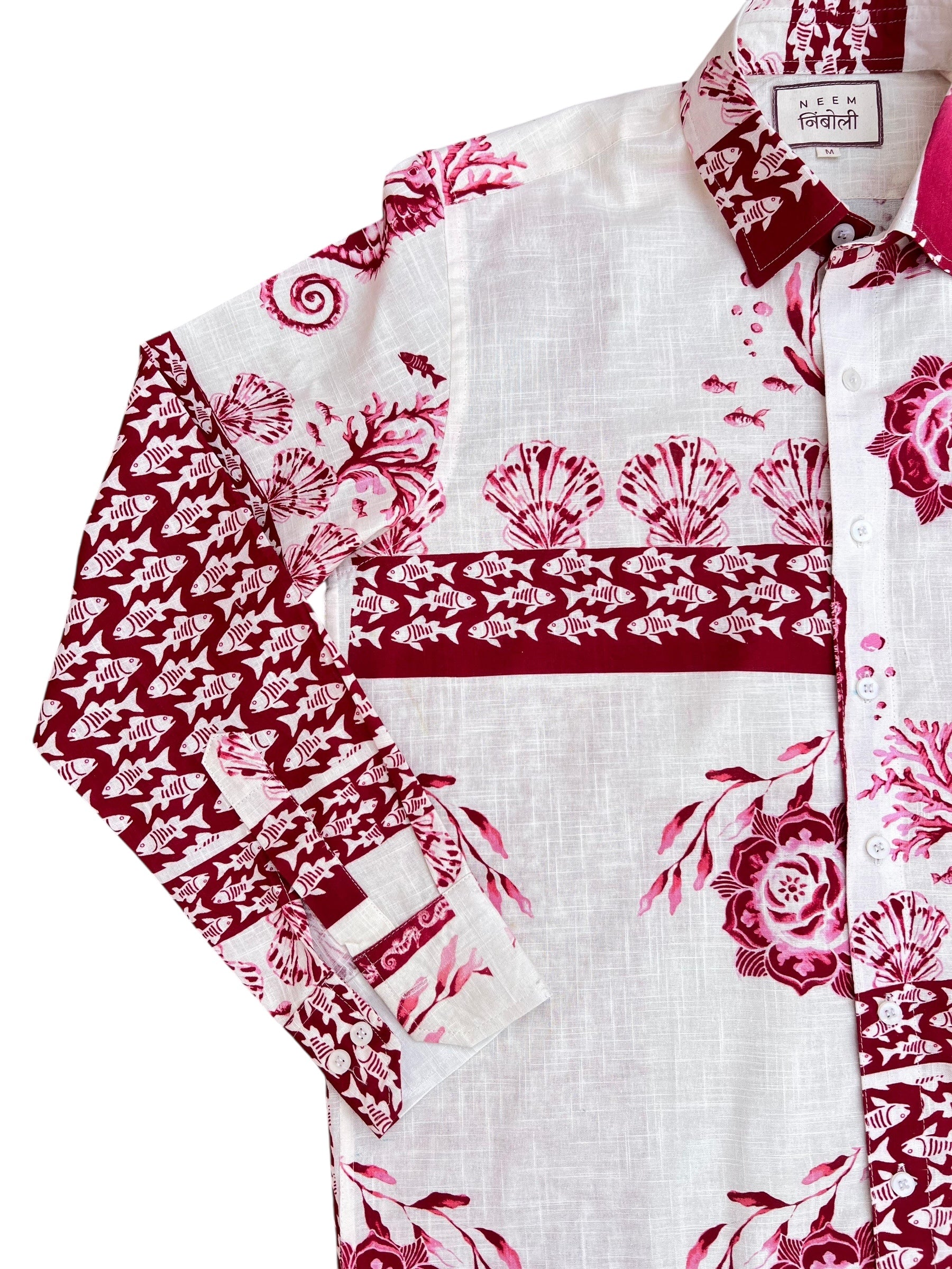 White shirt with red floral patterns on a white background