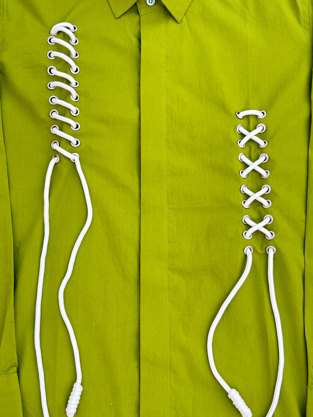 Green shirt with white laces 