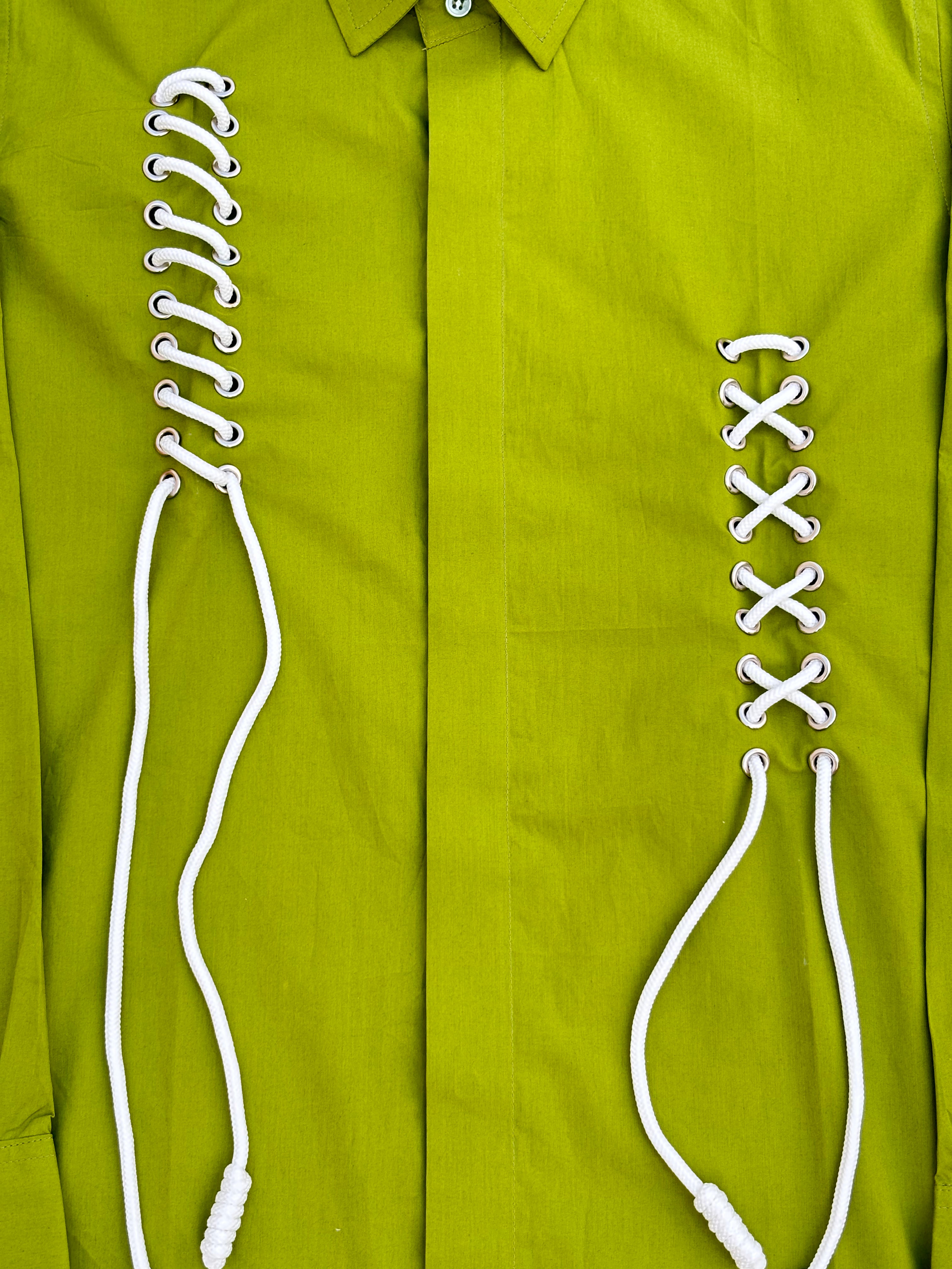 Green shirt with white laces 