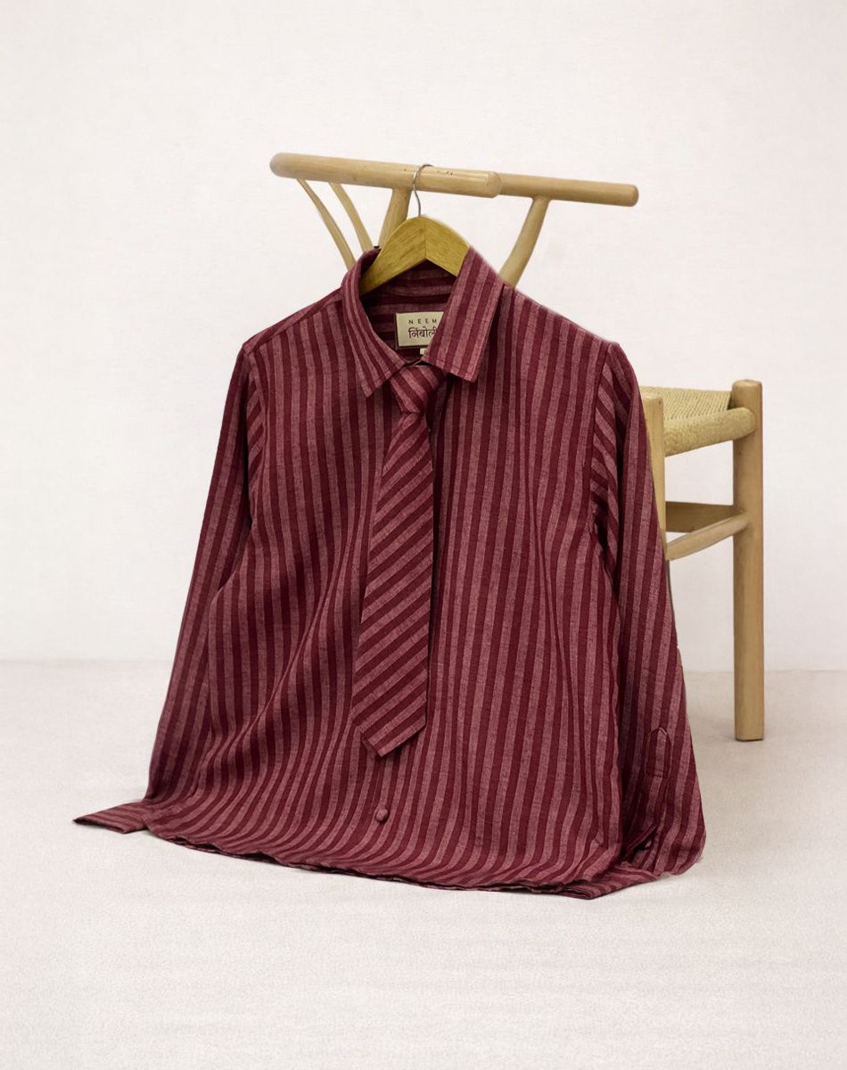 Maroon striped shirt on a hanger against a white background
