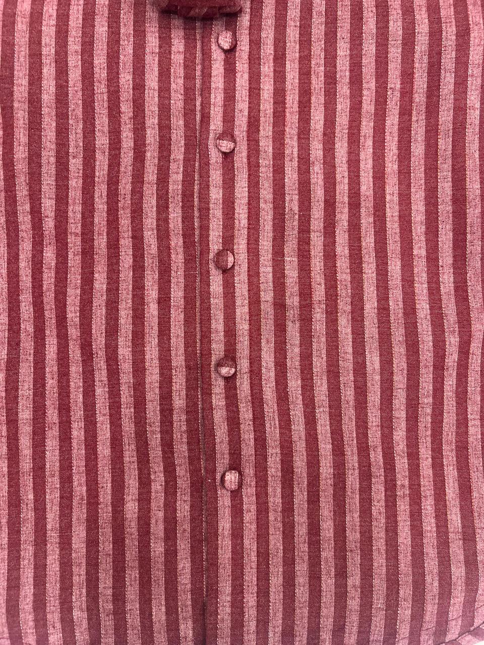 Close-up of a red and white striped shirt with buttons.