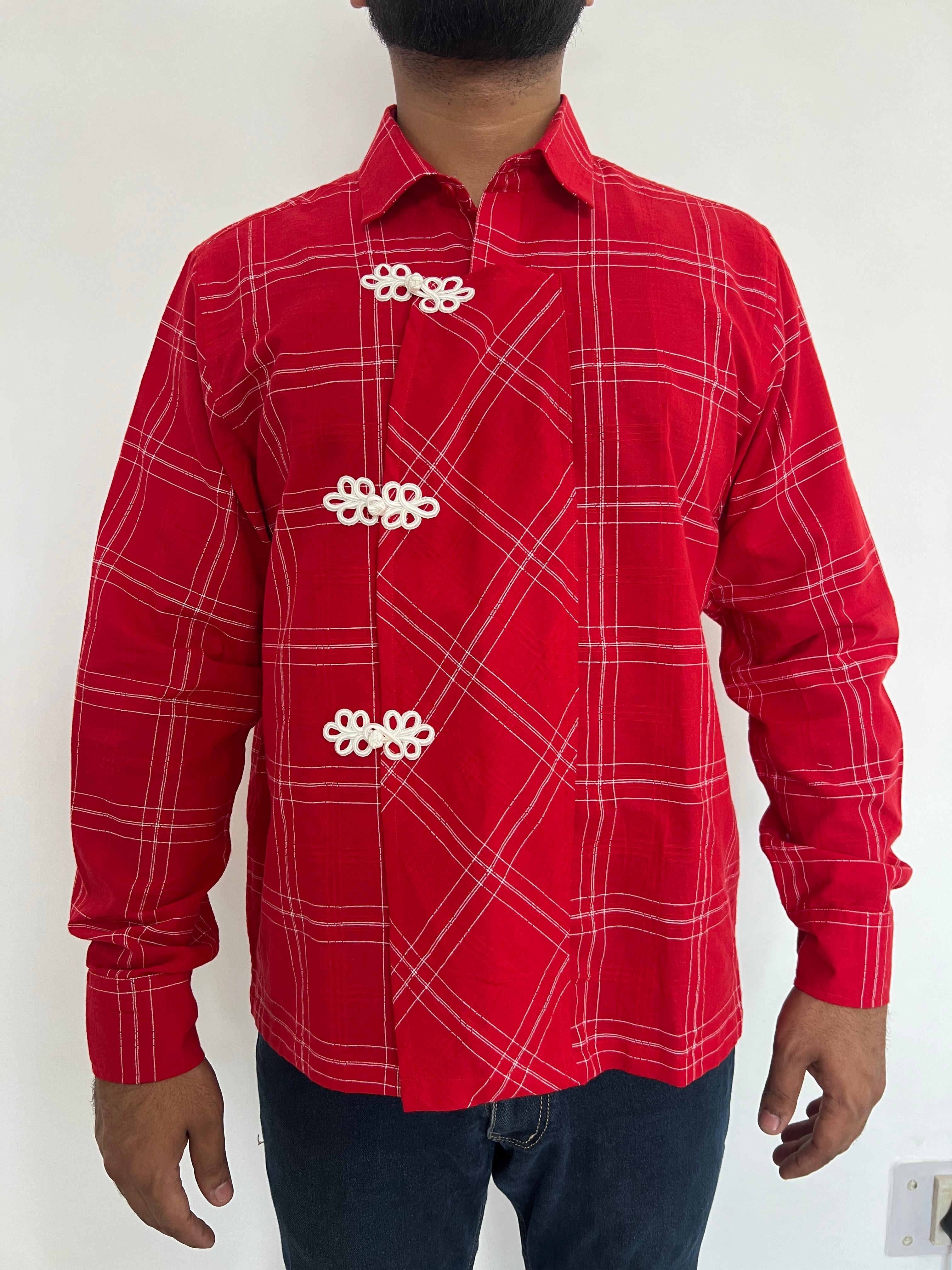 Red checkered shirt with white patterns worn by a person on a white background