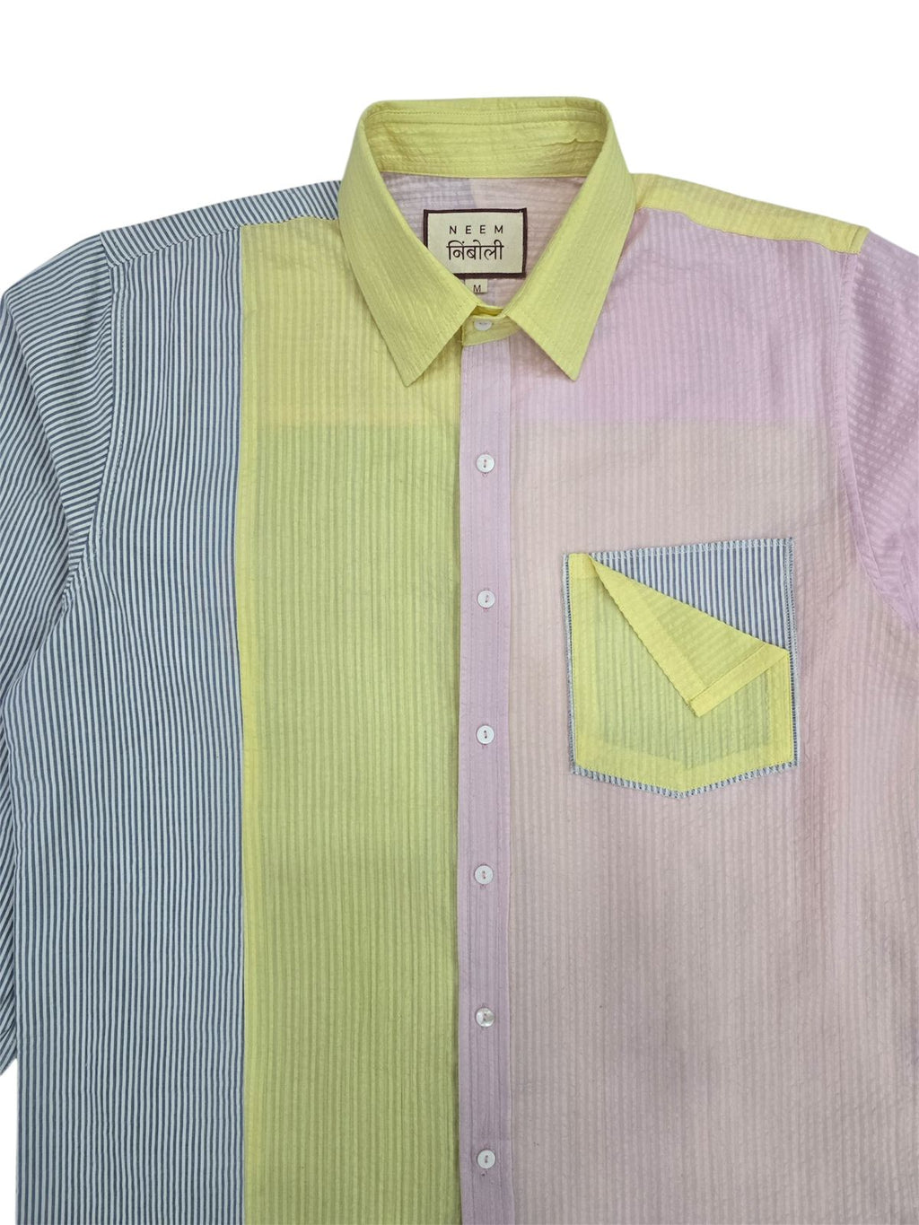 Shirt with green and purple pattern on a white background